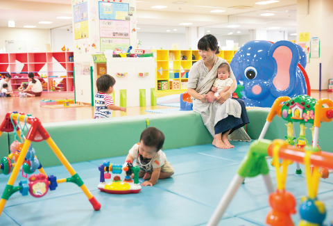 写真：子育て支援施設で遊ぶ子どもたちと親